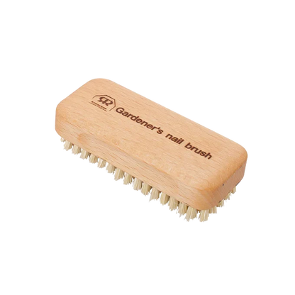 A wooden gardener's nail brush with light natural wood handle and cream-colored bristles, shown on a plain white background. The handle is engraved with the brand logo and the text 'Gardener's nail brush'.