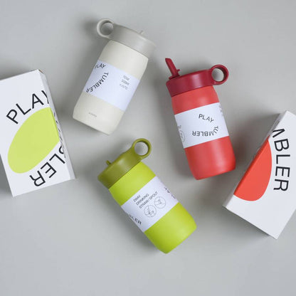 Assortment of PLAY TUMBLERS in various colors displayed next to their packaging.