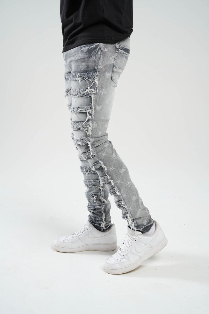 TAKER-PREMIUM STRETCH SLIM FIT JEANS WITH DISCHARGE PRINT & FRAYED PATCH