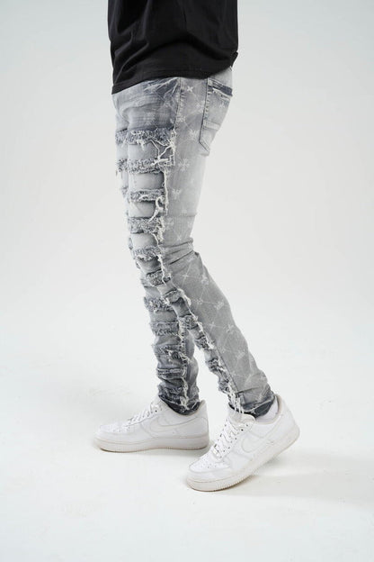 TAKER-PREMIUM STRETCH SLIM FIT JEANS WITH DISCHARGE PRINT & FRAYED PATCH